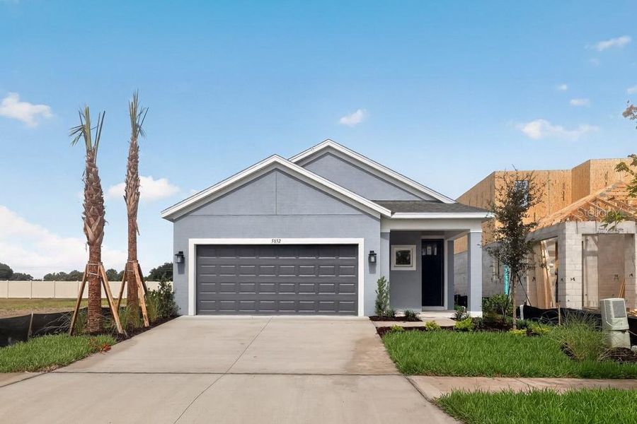 Front exterior of a new home in Indigo Creek, Apollo Beach, FL, highlighting curb appeal (Image 20). Front exterior of a new home in Indigo Creek, Apollo Beach, FL, highlighting curb appeal (Image 20).