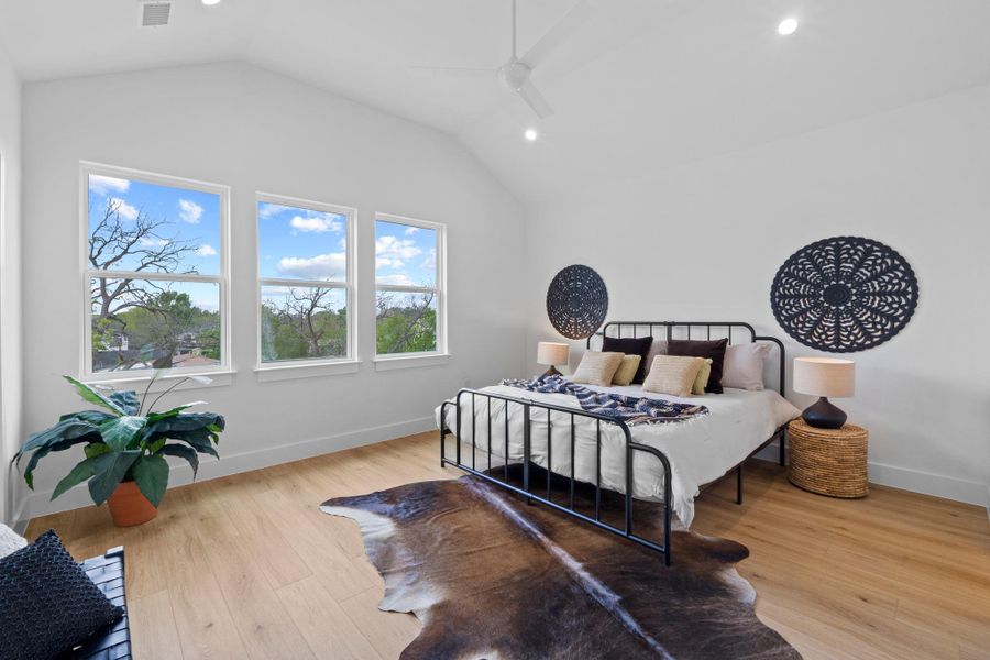 Bedroom with ceiling fan, light wood finished floors, lofted ceiling, and recessed lighting