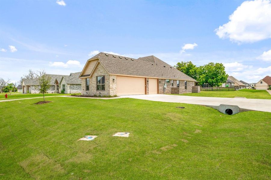 Front exterior of a new home in Pecan Plantation, Granbury, TX, highlighting curb appeal (Image 22).