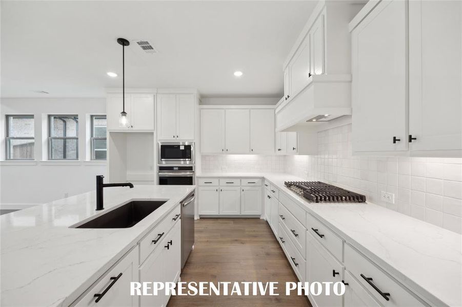 Beautiful counter tops, lovely cabinetry and modern stainless steel come together to create your dream kitchen!  REPRESENTATIVE PHOTO