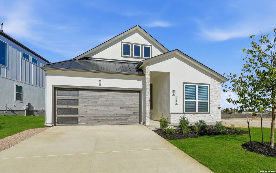 Front exterior of a new home in Prominence, San Antonio, TX, highlighting curb appeal (Image 23).
