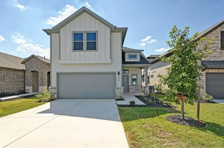Front exterior of a new home in Trinity Ranch, Elgin, TX, highlighting curb appeal (Image 2). Front exterior of a new home in Trinity Ranch, Elgin, TX, highlighting curb appeal (Image 2).