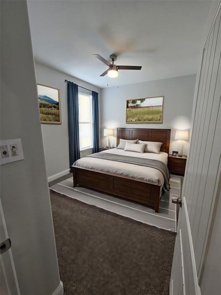 Carpeted bedroom featuring ceiling fan