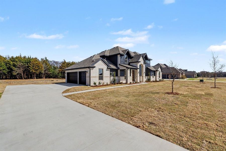Front exterior of a new home in Sagebrush Addition, Midlothian, TX, highlighting curb appeal (Image 21).