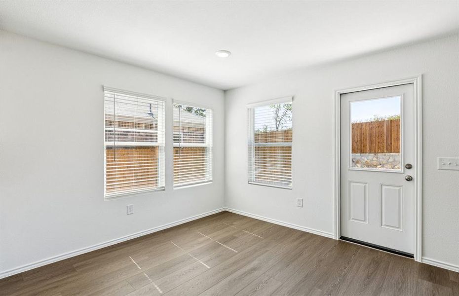 Dining nook off kitchen with large windows Dining nook off kitchen with large windows