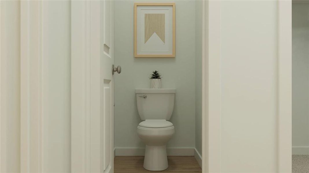 Bathroom featuring hardwood / wood-style flooring and toilet