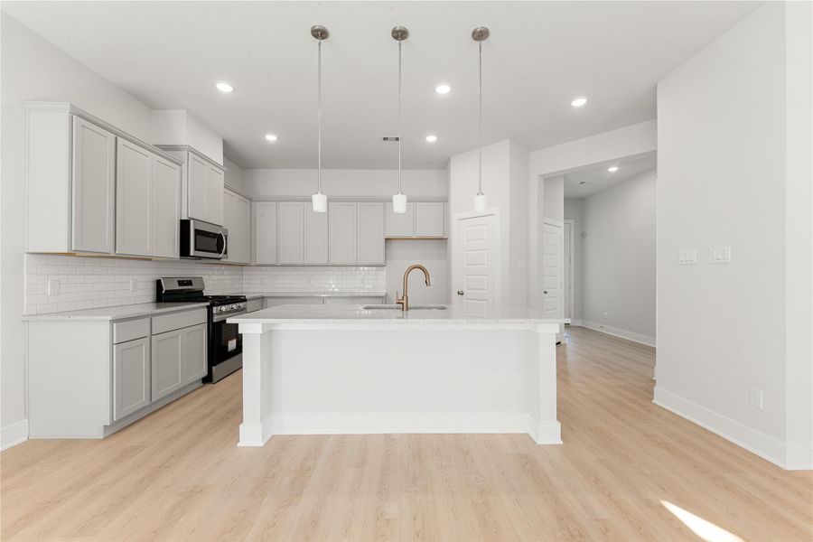 This bright and airy kitchen offers clean lines, sleek finishes, and a functional layout centered around a spacious island. Crisp white cabinetry and modern lighting elevate the design, creating a polished, contemporary feel that complements the home’s open-concept style. This bright and airy kitchen offers clean lines, sleek finishes, and a functional layout centered around a spacious island. Crisp white cabinetry and modern lighting elevate the design, creating a polished, contemporary feel that complements the home’s open-concept style.