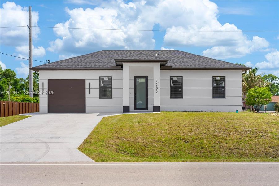 Front exterior of a new home in , Lehigh Acres, FL, highlighting curb appeal (Image 14).