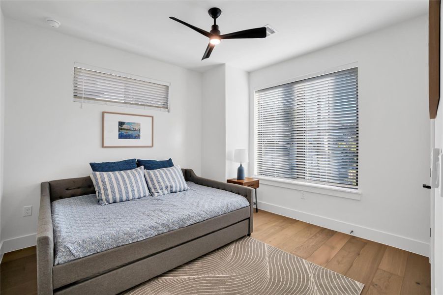 Bedroom featuring wood finished floors and a ceiling fan Bedroom featuring wood finished floors and a ceiling fan