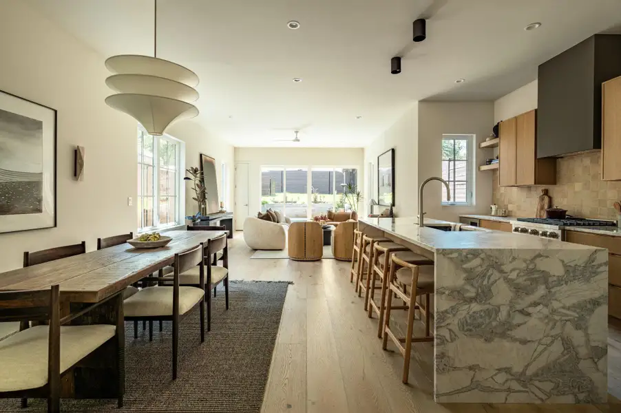 Gleaming hardwood floors and a marble island ground this expansive open concept space. Gleaming hardwood floors and a marble island ground this expansive open concept space.
