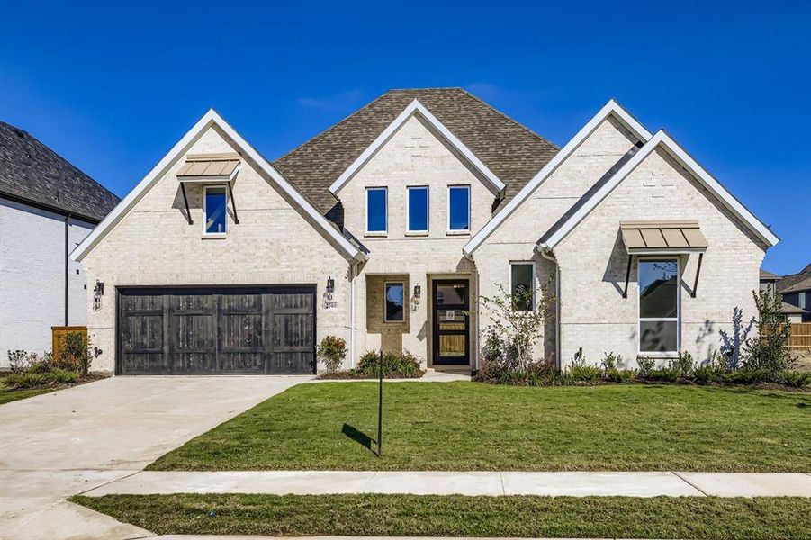 View of front of house with brick siding, a front yard, driveway, and a garage View of front of house with brick siding, a front yard, driveway, and a garage