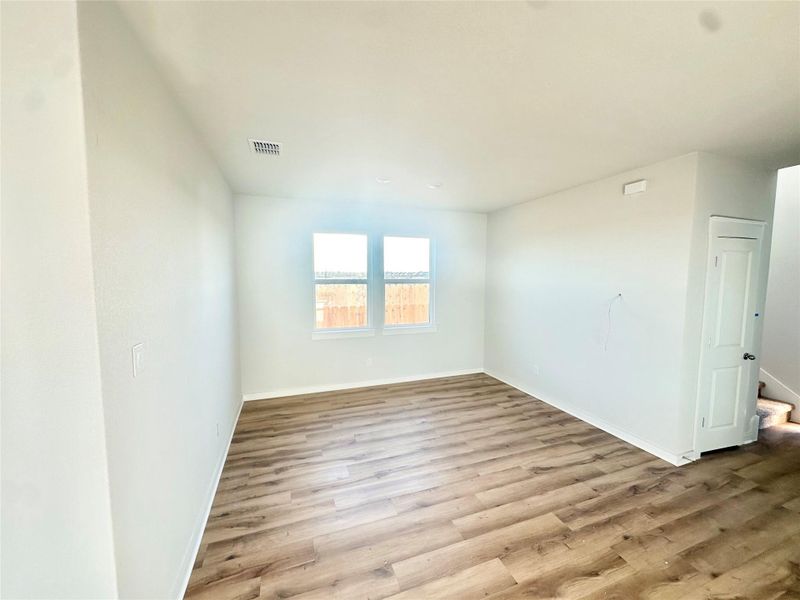Spare room featuring light wood-type flooring and baseboards