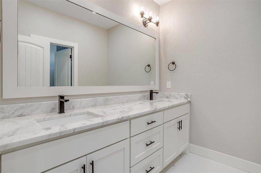 Bathroom with tile patterned flooring and vanity