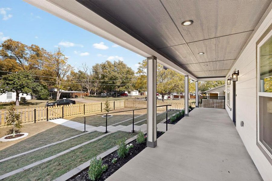 Covered porch featuring a lawn