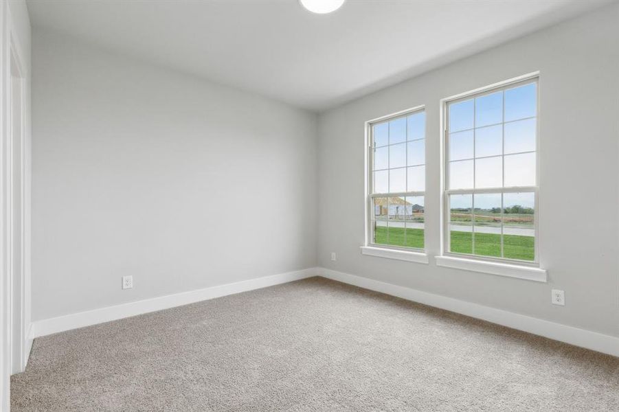 Spare room with carpet flooring and baseboards Spare room with carpet flooring and baseboards