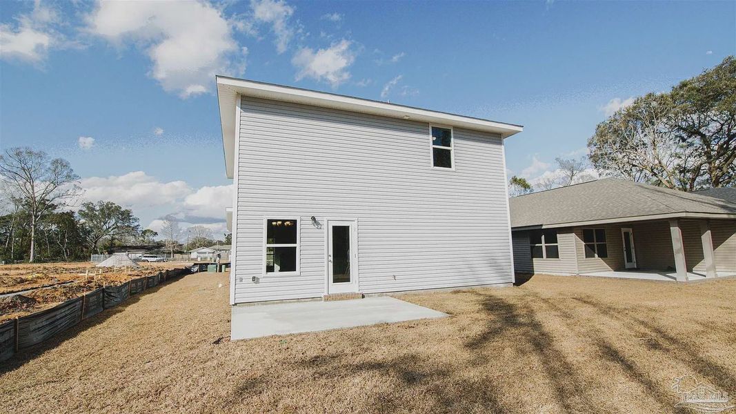 Front exterior of a new home in Pine Top, Cantonment, FL, highlighting curb appeal (Image 13).