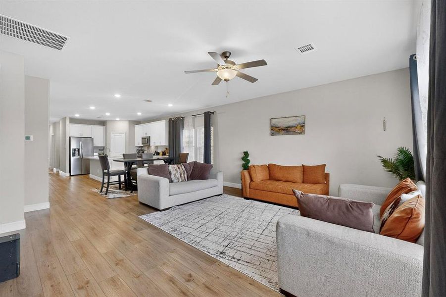Living area featuring recessed lighting, a ceiling fan, and light wood finished floors Living area featuring recessed lighting, a ceiling fan, and light wood finished floors