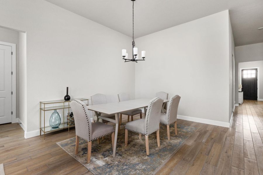 Formal dining space featuring chandelier and light brown tile floors