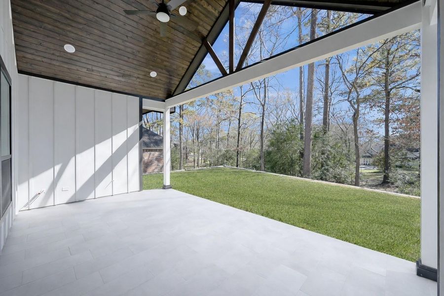 The large back patio with serene views of the backyard.