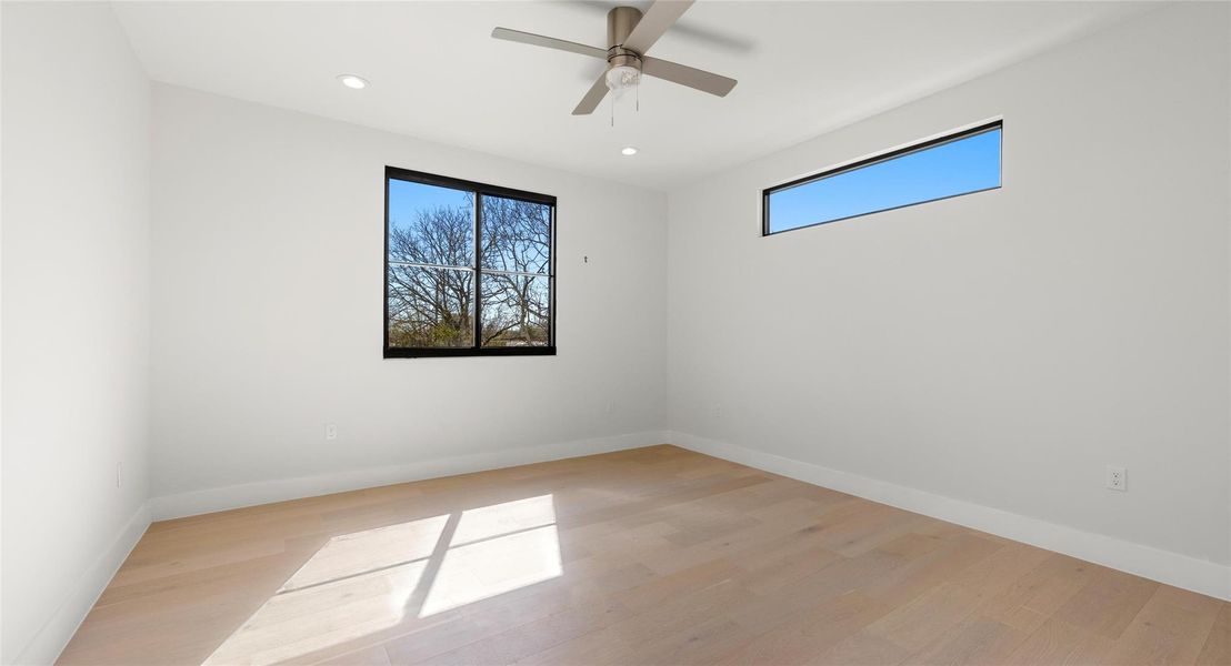 Empty room with recessed lighting, light wood-style flooring, and a ceiling fan