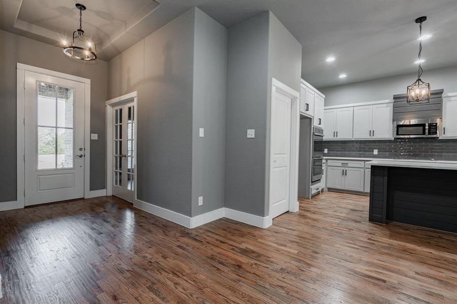 Entrance foyer featuring an inviting chandelier, baseboards, recessed lighting, and light wood-type flooring Entrance foyer featuring an inviting chandelier, baseboards, recessed lighting, and light wood-type flooring