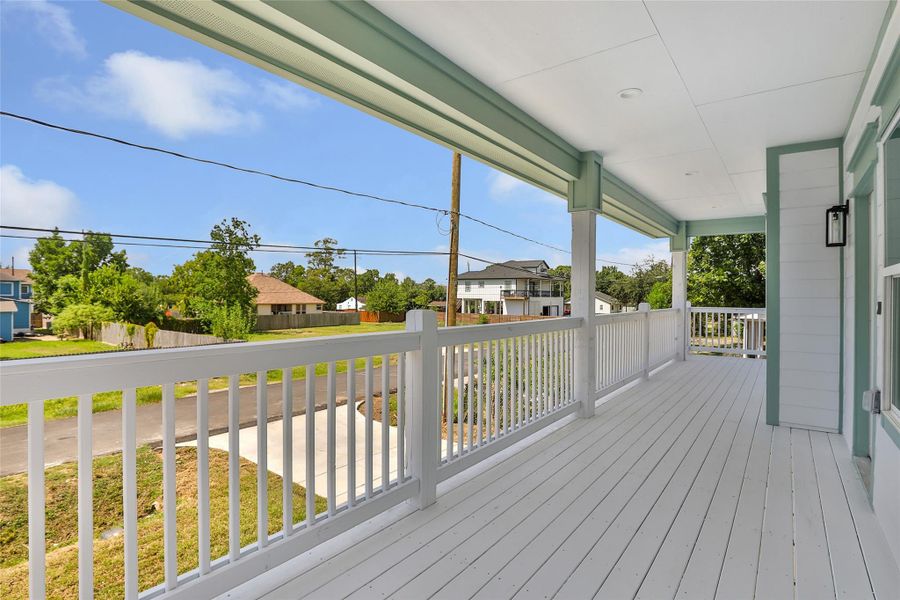 Spacious covered porch offers a relaxing outdoor space with charming neighborhood views.