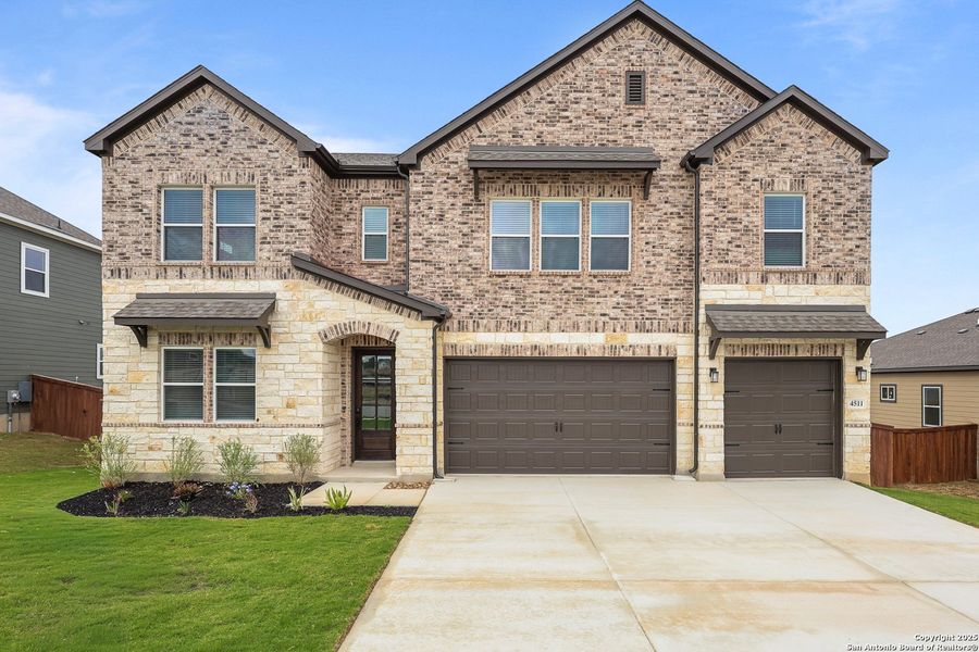 Front exterior of a new home in Homestead, Schertz, TX, highlighting curb appeal (Image 1).