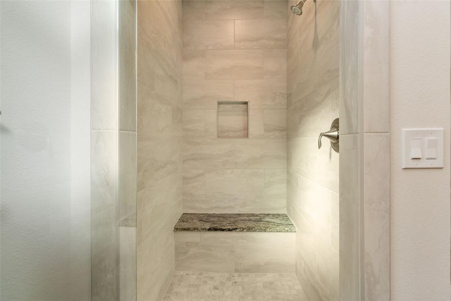 Primary ensuite with walk-in shower and frameless glass door