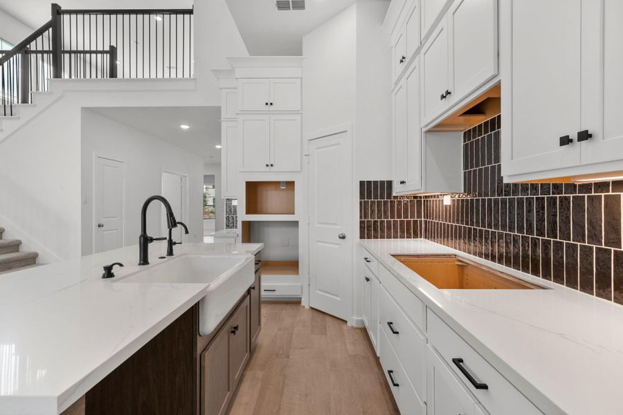 Expansive Kitchen With Oversized Island And Designer Touches