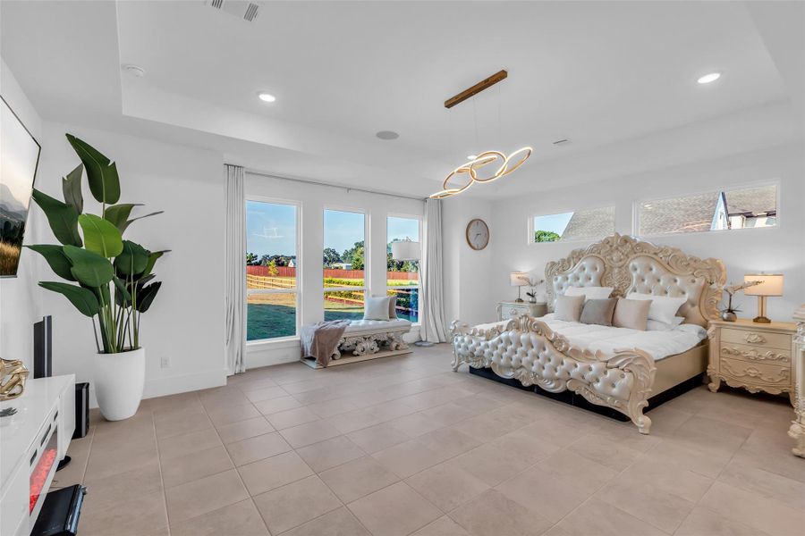 Primary Bedroom View:From the comfort of the primary suite, walls of glass frame serene views of the sparkling pool and expansive grounds. Every morning begins with light, and every evening ends with the luxury of resort-style living just beyond your bed.