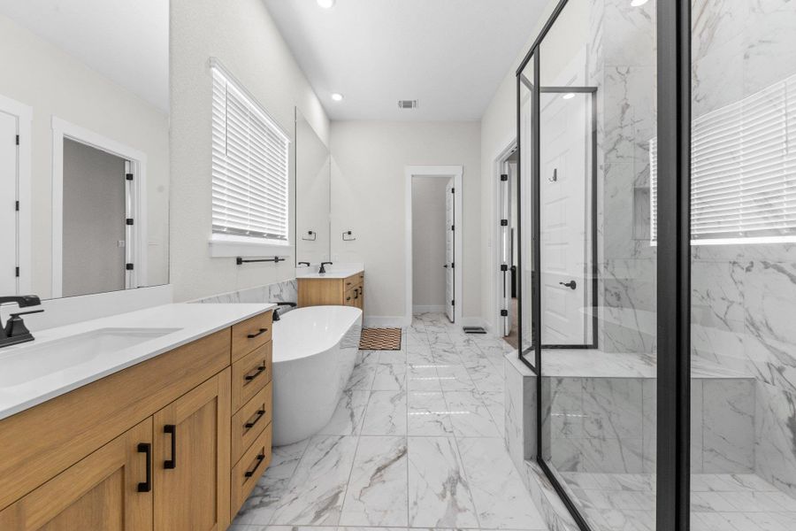 Full bath featuring a marble finish shower, visible vents, a soaking tub, marble finish floor, and a sink