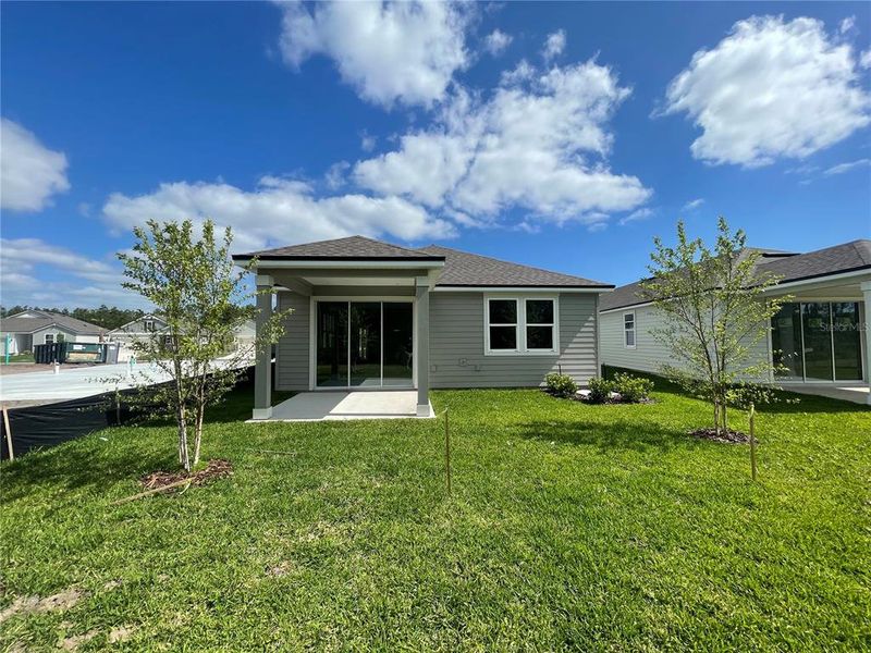 Front exterior of a new home in Palm Series at Seminole Palms, Palm Coast, FL, highlighting curb appeal (Image 18).