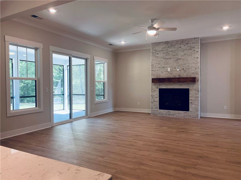 This bright living area features a charming firepl