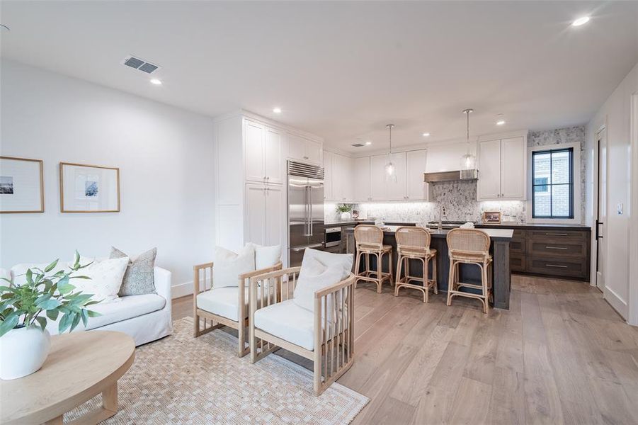 Living room with sink and light hardwood / wood-style floors