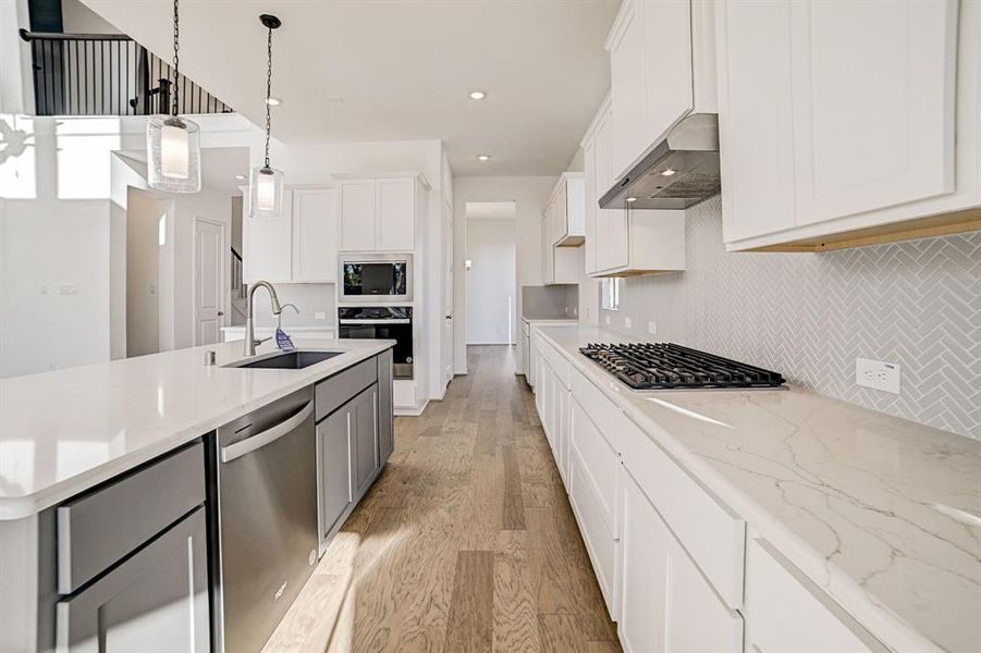 Beautiful quartz countertops extend all the way to the butler's pantry that walks directly into the dining space.