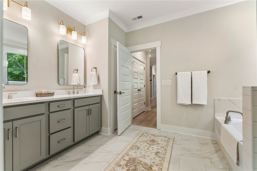 This spacious bathroom offers a double vanity and This spacious bathroom offers a double vanity and