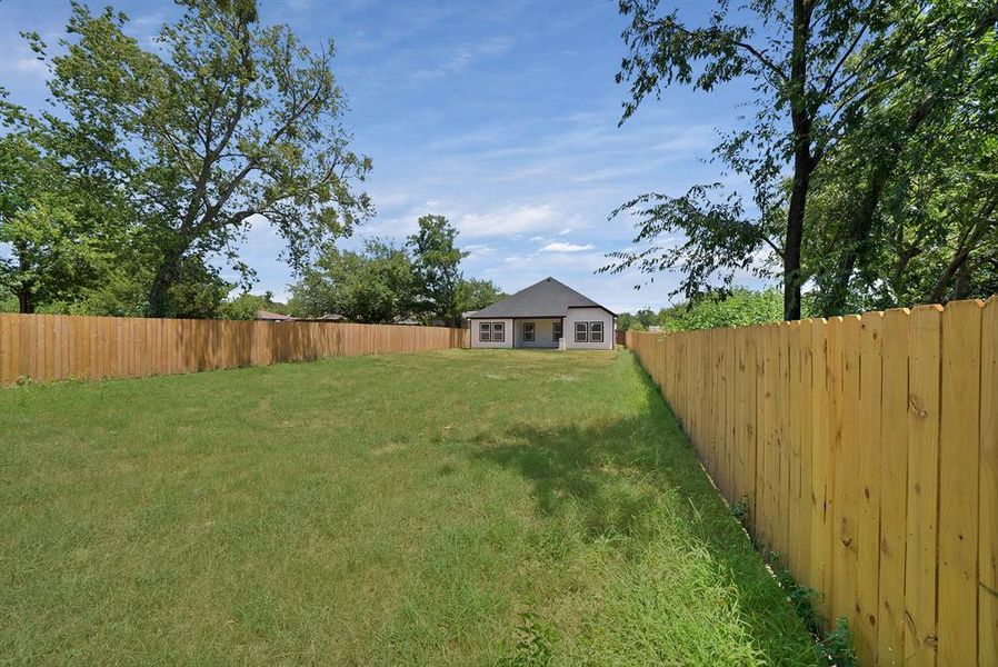 View of fenced backyard
