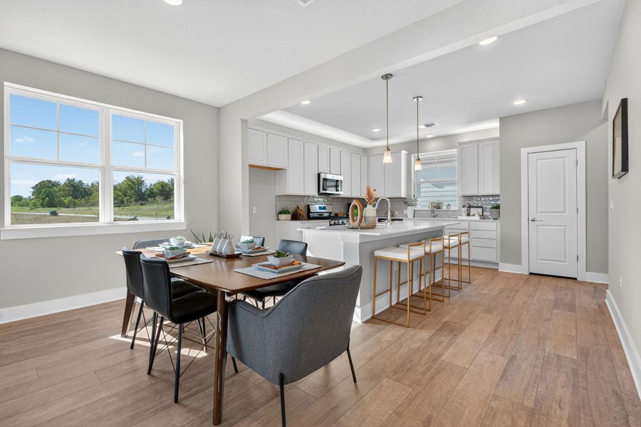 Dining area featuring light wood-style floors and recessed lighting