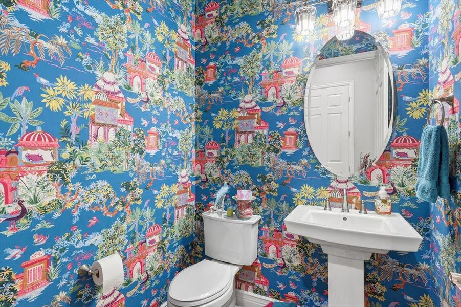 Elegant Powder Room featuring a Pedestal Sink, Striking Designer Wallpaper Detail, and Designer Lighting.