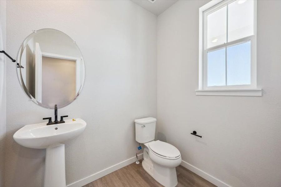 A bathroom with a mirror and sink.