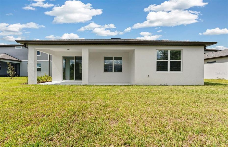 Exterior details and patio area of a home in Riverwood, Zephyrhills (Image 3).