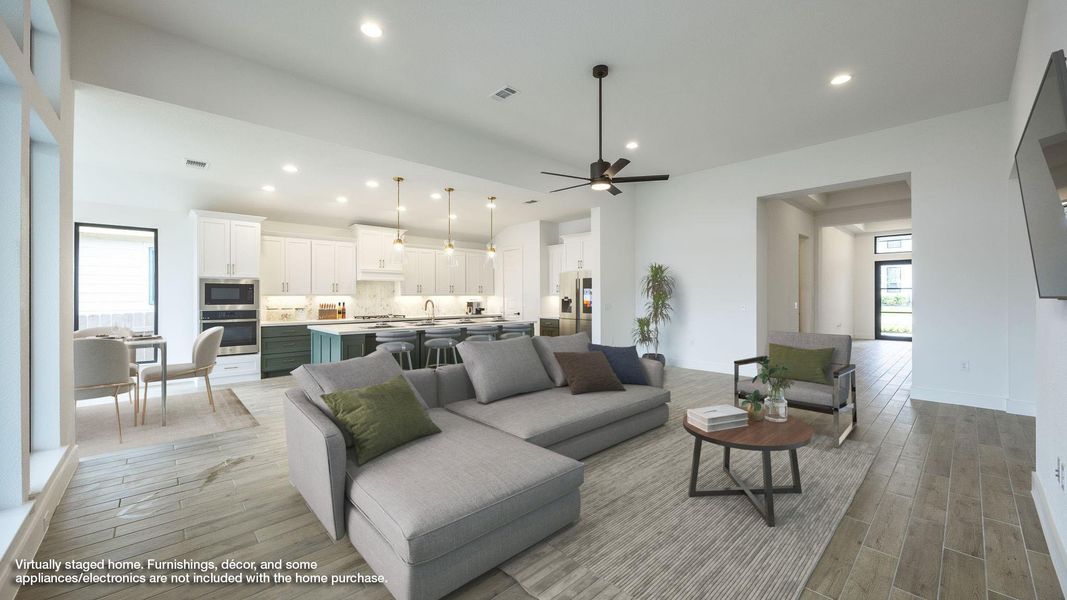 Living room featuring light wood finished floors, recessed lighting, and a ceiling fan Living room featuring light wood finished floors, recessed lighting, and a ceiling fan