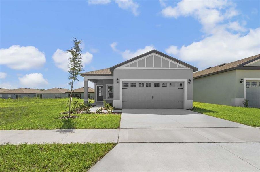 Front exterior of a new home in Gum Lake Preserve, Lake Alfred, FL, highlighting curb appeal (Image 15). Front exterior of a new home in Gum Lake Preserve, Lake Alfred, FL, highlighting curb appeal (Image 15).