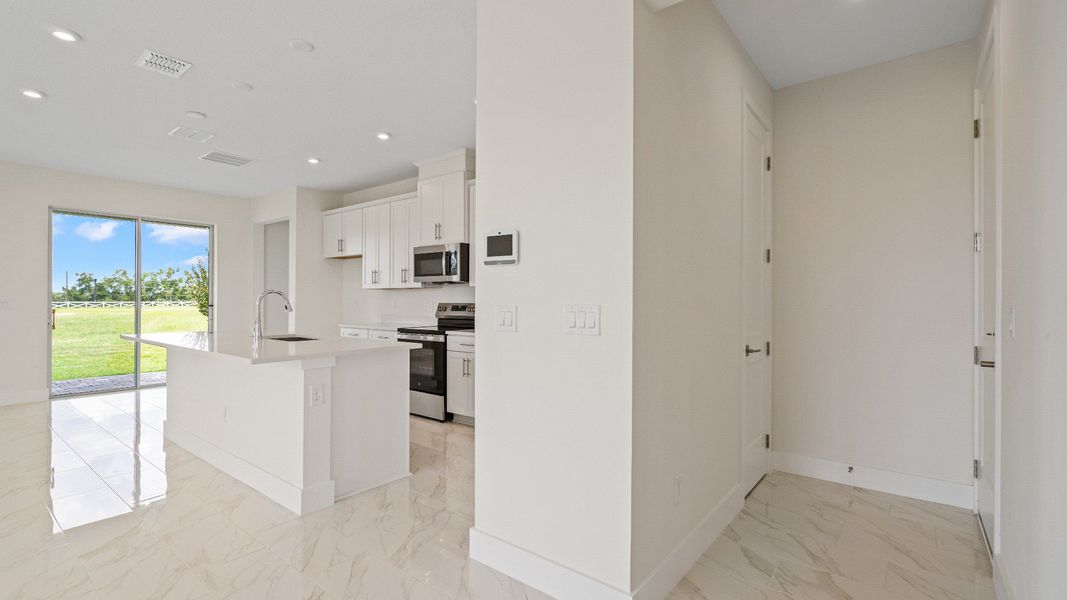 The Sweetgum Spacious and Bright Kitchen and garage entry two story home in Trailside in Mount Dora by DRB Homes