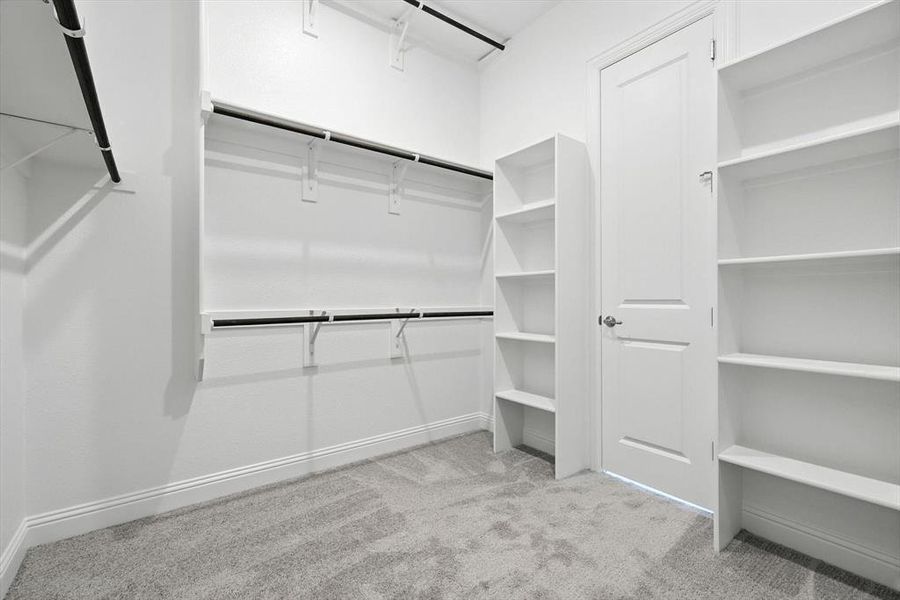 Walk in closet with light colored carpet Walk in closet with light colored carpet