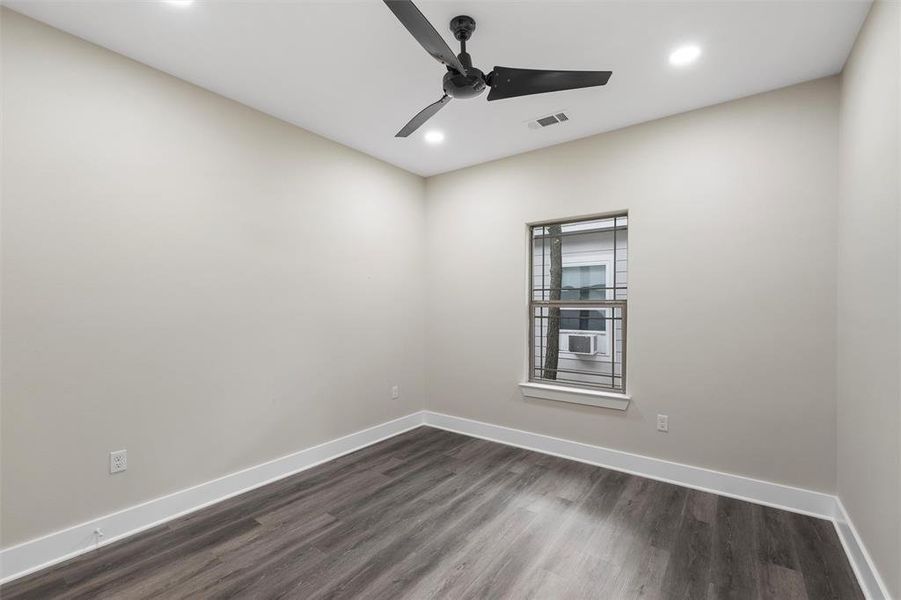 Spare room featuring recessed lighting, dark wood finished floors, baseboards, ceiling fan, and cooling unit