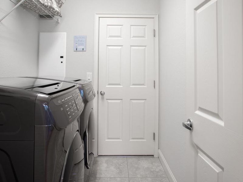 Convenient laundry room at garage entry - Willow II by Highland Homes