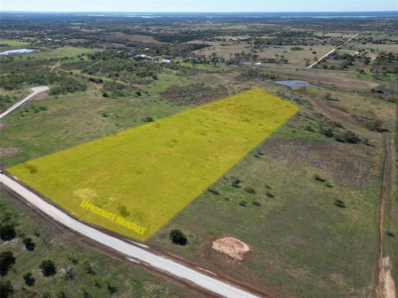 Aerial view of sparsely populated area with property parcel outlined