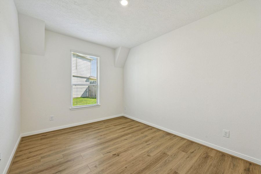 The Den is a versatile and additional living space that can be used as a home office, hobby or play room. It features vinyl plank flooring, high ceilings, large window with privacy blinds and neutral paint.