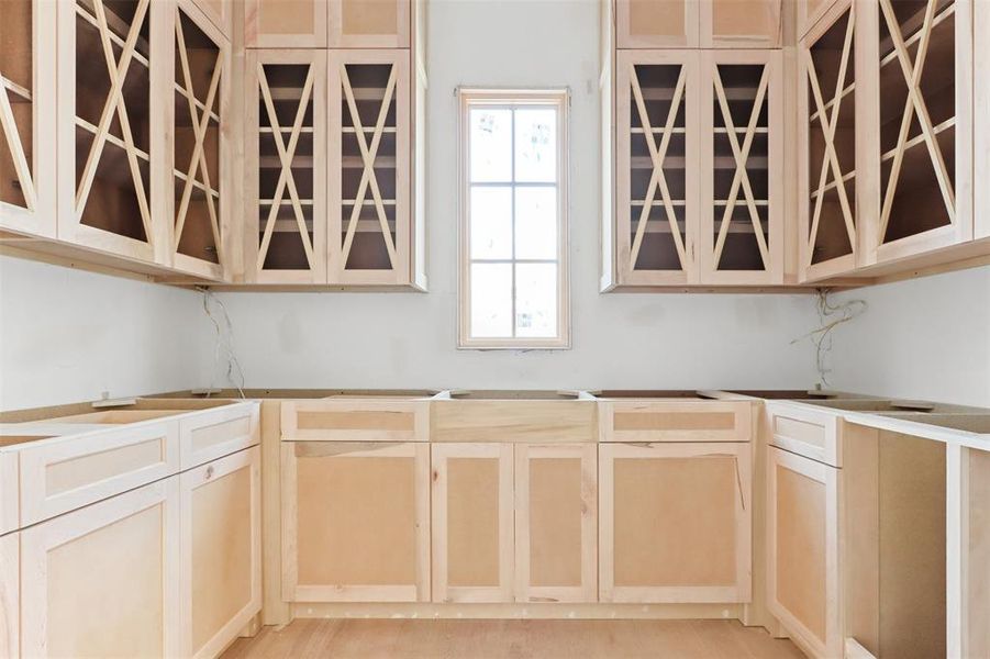 Kitchen featuring light brown cabinetry and light hardwood / wood-style floors